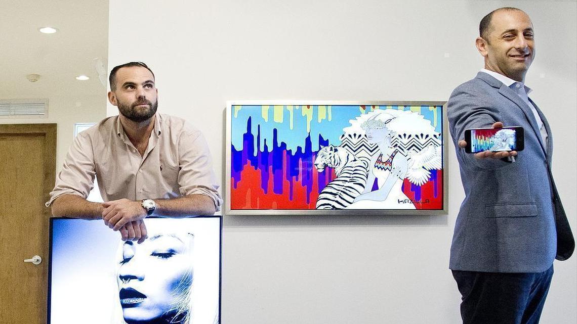 Blackdove, a Miami-based tech startup, offers a global platform and marketplace for digital motion art. Founders Tito Gaudenzi, left, and Marc Billings are shown with samples of the art. On the wall is “Urban Decay” by Kazilla; Gaudenzi holds “whtEyesRoses” by jon Cates.