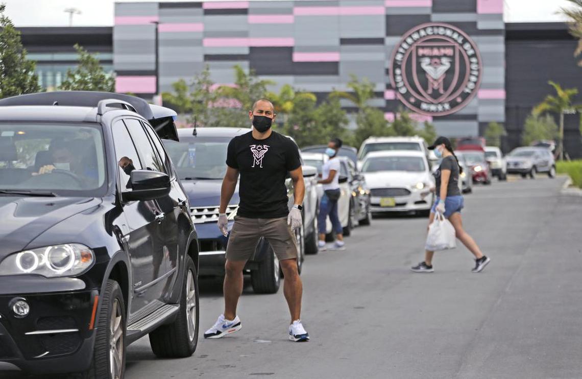Inter Miami CF goalkeeper Luis Robles helps load bags of food at the DeliverLean Cares food distribution at Inter Miami CF Stadium in Fort Lauderdale on April 29. Inter Miami CF was working with DeliverLean, the Urban League of Broward County, and cooperation from Sysco Southeast Florida.