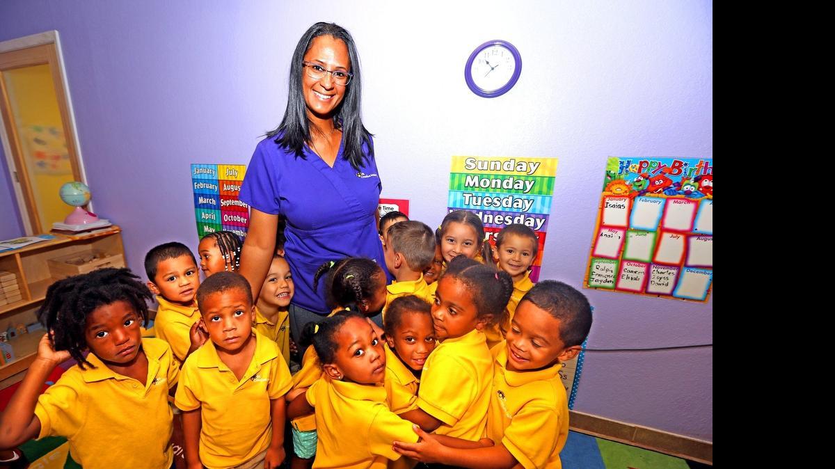 
Evelyn Taveras is surrounded by the students in her one of her classes at the Bee Creative Academy West Park  on May 20. 

