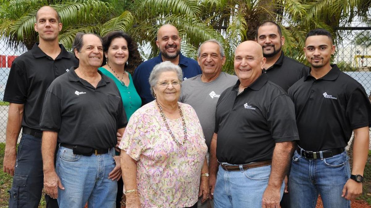 From left: Emilio Sixto Jr., slitter operator; Emilio Sixto Sr., vice president; Maria Sixto, accounting/human resources; Andy Sixto, production manager; Carmen Sixto, CEO and co-founder; Andres Sixto, vice president; Felipe H. Sixto, vice president; Felipe E. Sixto, director of sales, marketing and strategic planning; and Felipe I. Sixto, slitter operator. (A slitter operator runs machines that cut and modify metal or plastic for industrial use.)