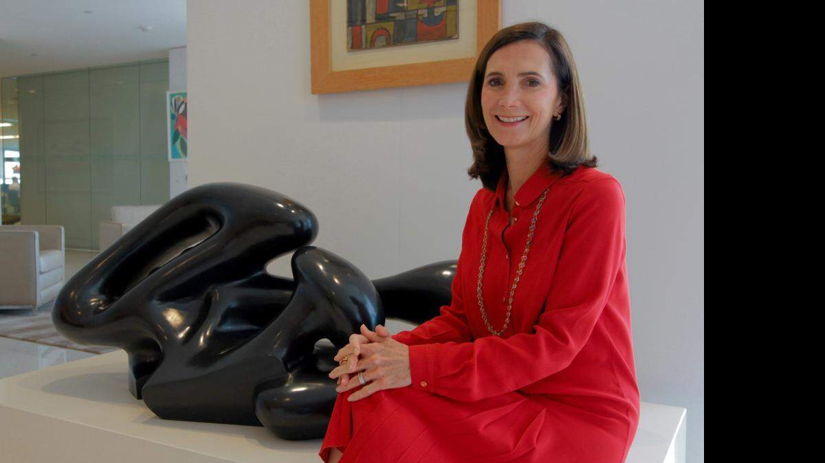 
HOMEGROWN: CEO of Itau Private Bank International, Frances Sevilla-Sacasa, sits next to artwork at her Southeast Financial Center office in Miami.
