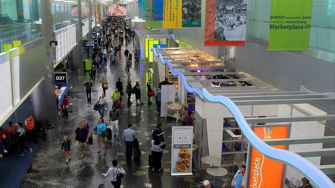 Travelers walk through the expanded North Terminal and its newly opened Marketplace, a collection of nine restaurants and shops between gates D26 and D29, on Wednesday April 5, 2017.