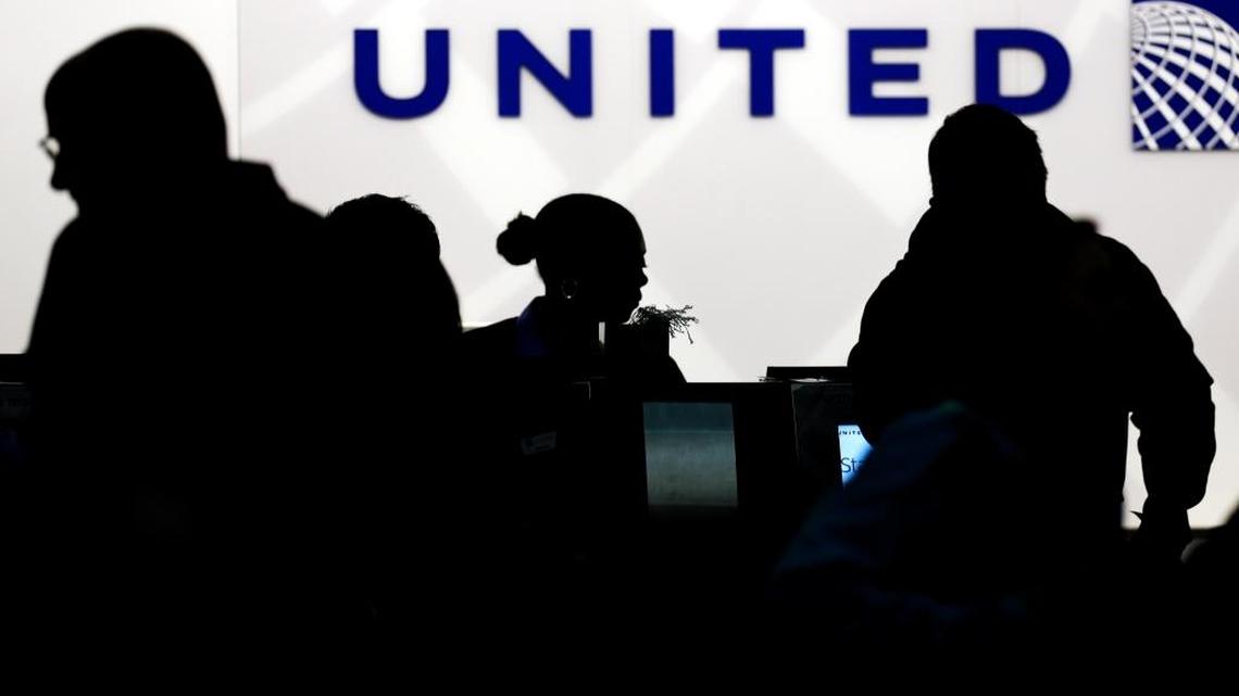 In this Saturday, Dec. 21, 2013, file photo, travelers check in at the United Airlines ticket counter at Terminal 1 in O’Hare International Airport in Chicago. After a man was dragged off a United Express flight on April 9, United Airlines becomes the butt of jokes online and on late-night TV. Travel and public-relations experts say United fumbled the situation from the start, but it’s impossible to know if the damage is temporary or lasting.