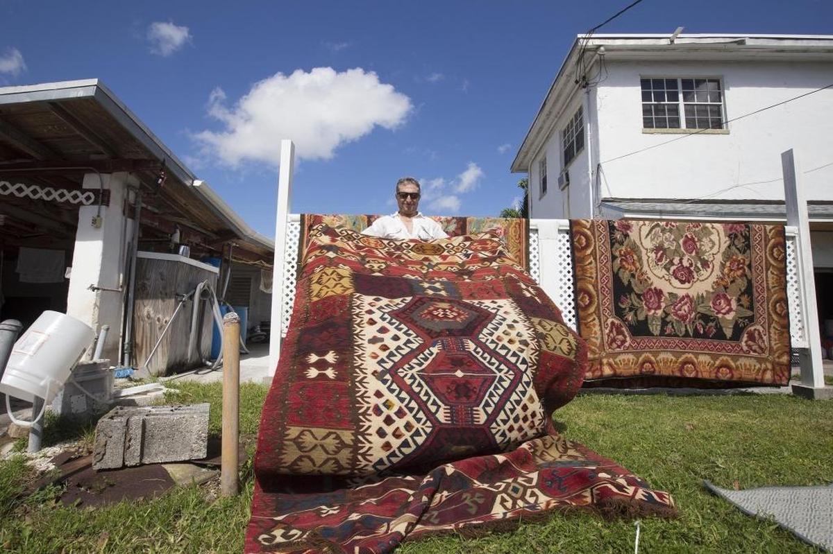 Terry Kondralian performs post-storm remediation work on rugs on Nov. 8.