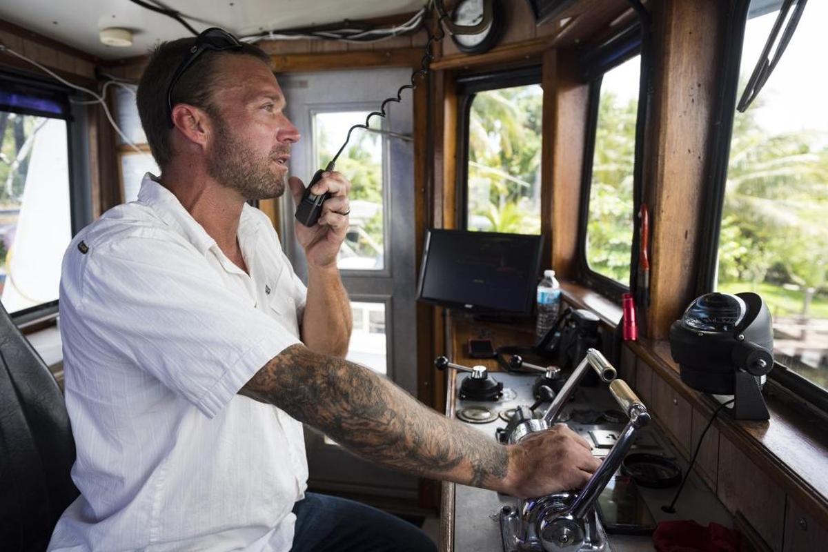 Antillean Marine Shipping Corp. Capt. Morgan Van Vleet requests the opening of a drawbridge as he steers his tug on June 29.