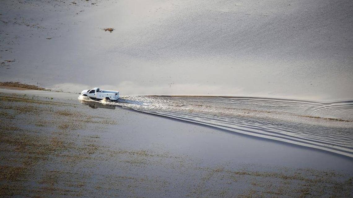 A truck drives through a flooded field in an agricultural area after Hurricane Irma passed through the area on Sept. in Homestead, Florida.