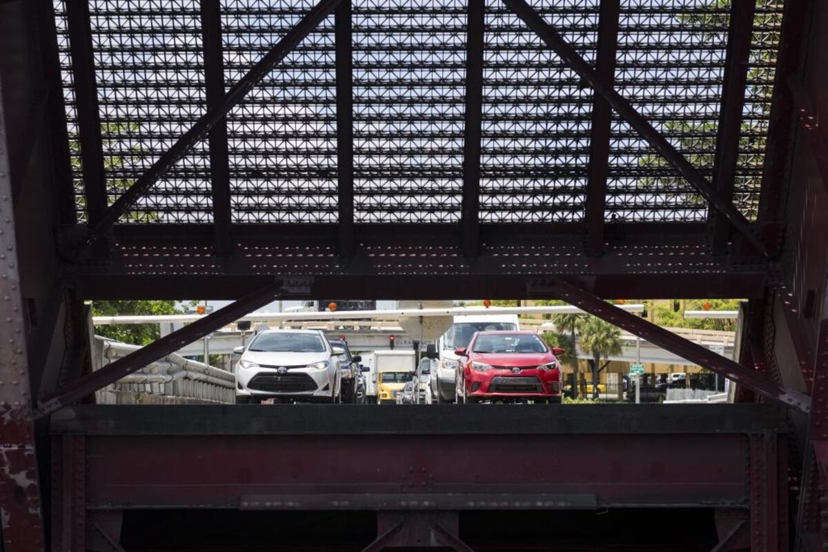 One of the seven drawbridges the Antillean Marine cargo boats pass by in the Miami Canal opens on Thurs., June 29, 2017.