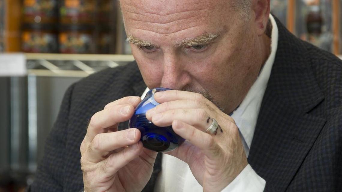 
David Neuman, chief executive officer of GAEA North America, demonstrates sampling olive oil by first sniffing it at the headquarters for North America in Hollywood on Aug. 5, 2015. 
