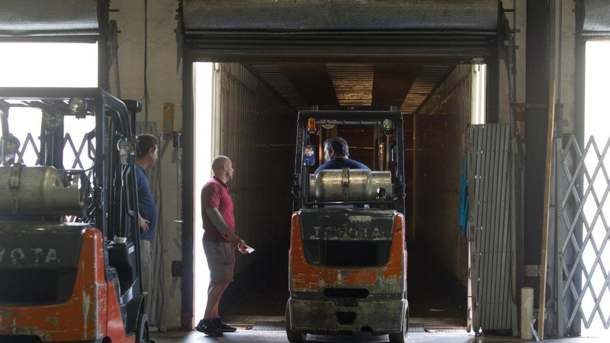 Workers load a truck at the regional headquarters of Kuehne + Nagel logistics and transportation company in Doral.