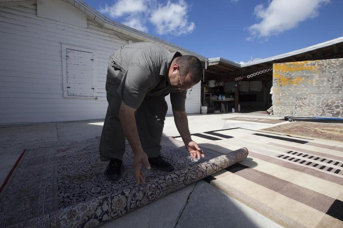 Paul Kondralian works on a carpet at Hilliard Rug Cleaners in South Miami.