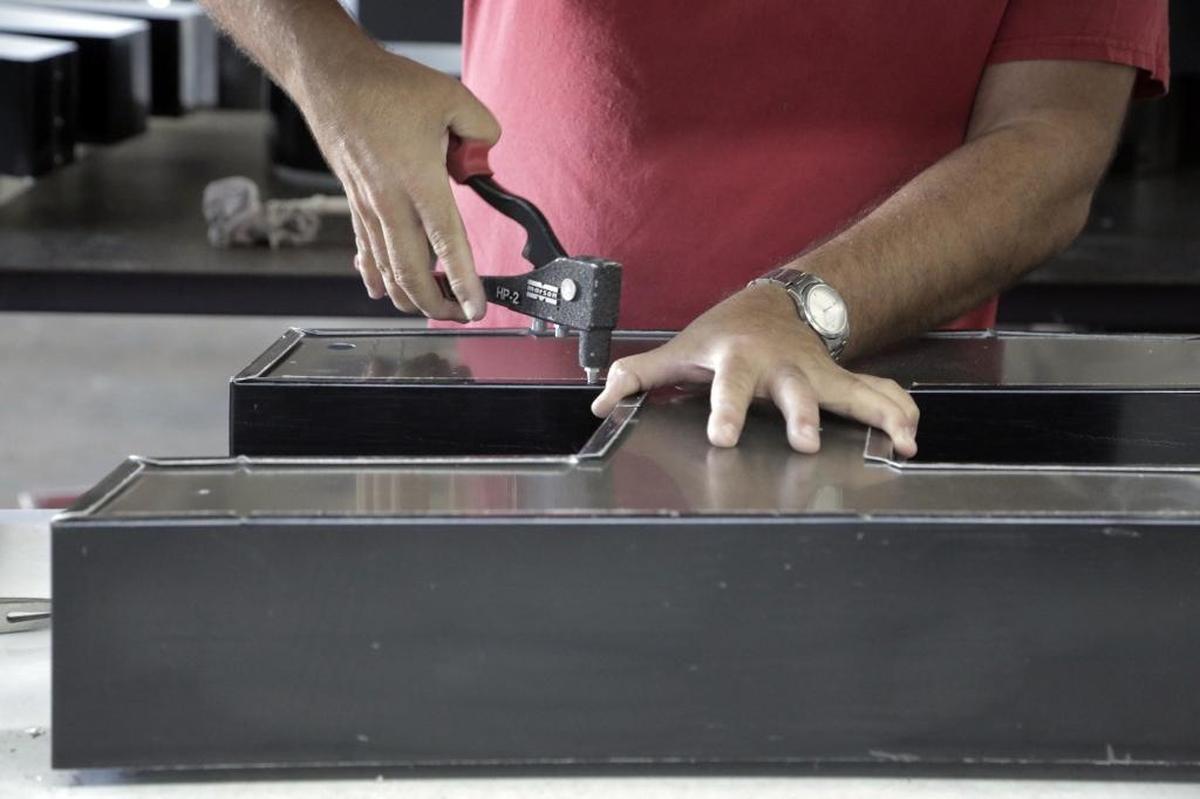 David Pineiro assembles a letter for a sign.
