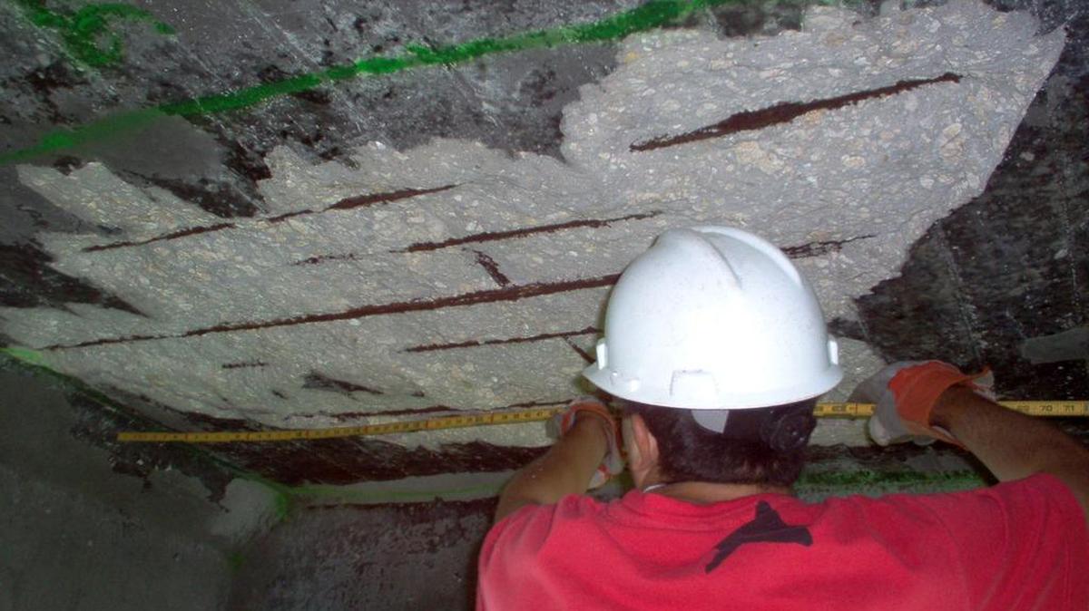Longitudinal cracks along beams become spalls when concrete cover is lost in most cases; as the picture shows, rebar is exposed.