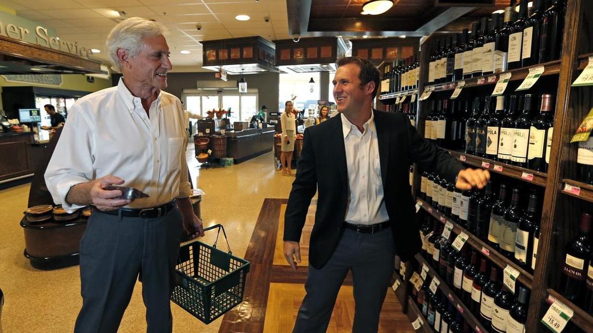 Customer Jeff Brandon, who is also a commercial real estate developer with Tyler Milam, at right, in the aisles at the Milam store at 5767 Bird Rd., which has been renovated.