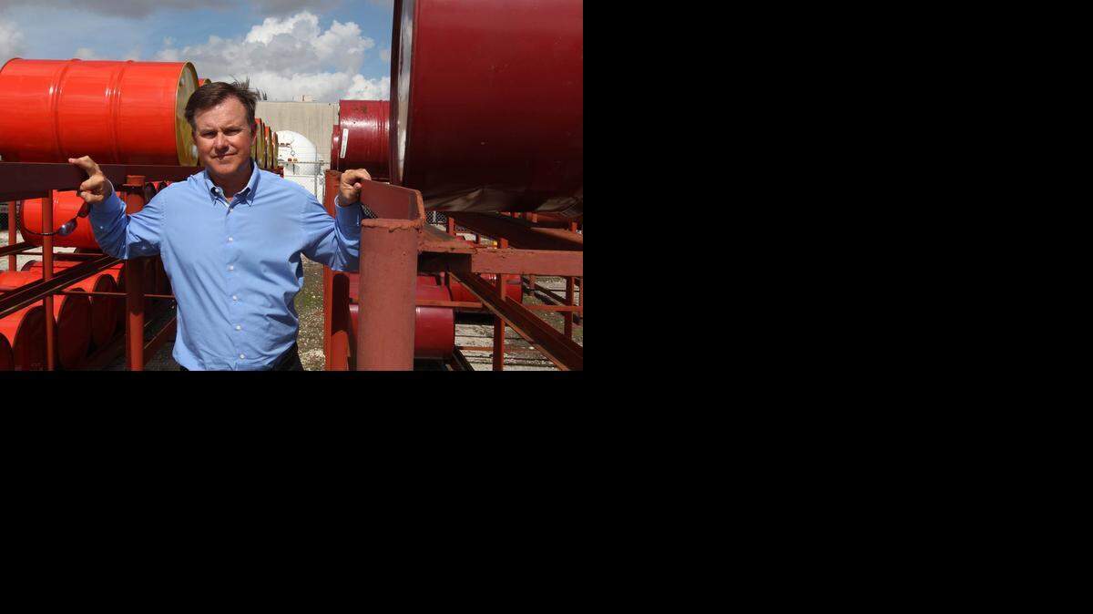
Stephen Gorey, is the president of Tropic Oil, a 62 year old company that uses its own fleet of trucks to distribute bulk fuel and lubricants to marine, aviation, and industrial customers. Stephen stands in a field of oil barrels on the company grounds, Wednesday, October 15, 2014. 
