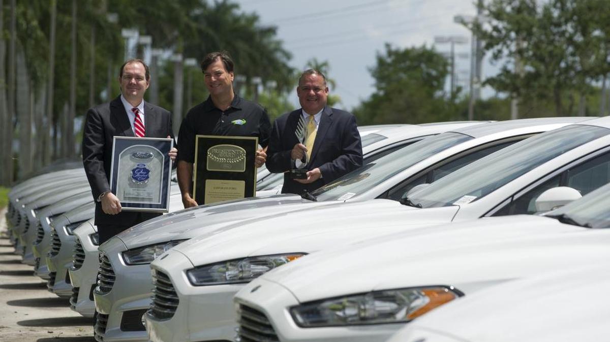 
Patrick O'Neill, Miami regional manager for Ford Motor Company, left, David Menten, president of Sawgrass Ford, middle, and Steve Smith, Miami regional manager for Ford Motor Credit Company, hold corporate awards that were handed out during a ceremony earlier in the day at the Sawgrass Ford dealership in Sunrise on July 24, 2015.
