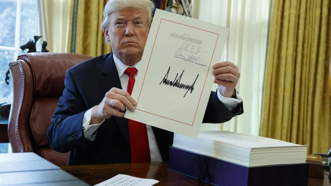 President Donald Trump shows off the tax bill after signing it in the Oval Office of the White House on Dec. 22. It will be interesting to see what happens to economic growth with the new tax law over an extended time, because depending on which economist you listen to, forecasts vary from short-term blips in growth to long-term, extended growth, says James S. Cassel, co-founder and chairman of Cassel Salpeter & Co.