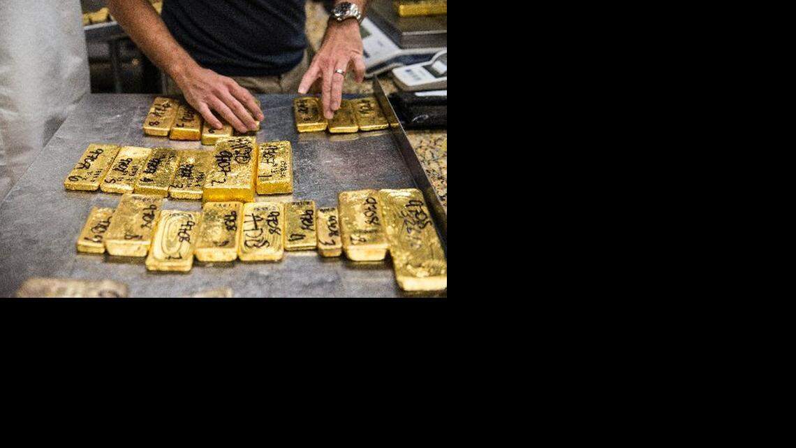 
Jorge Ramirez organizes gold bullion for invoicing prior to testing the purity of each bar at Kaloti Metals & Logistics, a gold and precious metals trading house, in downtown Miami's jewelry and diamond district on Friday, Dec. 12, 2014.
