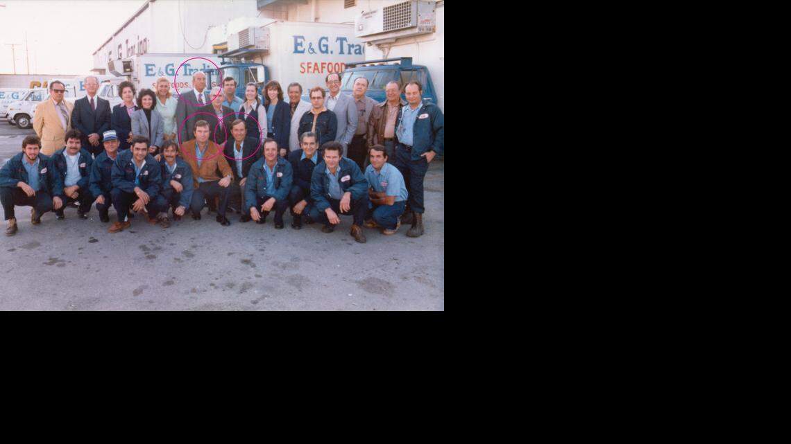 THE FOUNDING GROUP: This photo was taken in 1980 at E&G Trading in Hialeah, the predecessor company to Quirch Foods. It shows part of their warehouse and office as well as their employees. Guillermo Quirch Sr. is seen, circled, in the second row. Eduardo Quirch, left, now deceased, and his brother Guillermo Quirch II are in the front row center, also circled.

