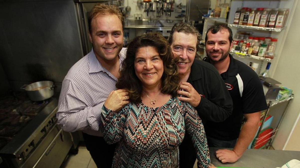 
Rachel and Larry Gebaide, center, and their sons Chris Gebaide, right, and Michael Mack are the owners of Tastebuds Catering in Davie, founded in 1995. 
