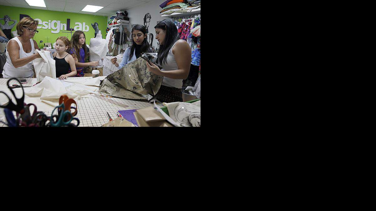 
Trend setters: Angie Cohen, left, founder/creative director instructs her students during a fashion class at DesignLab.
