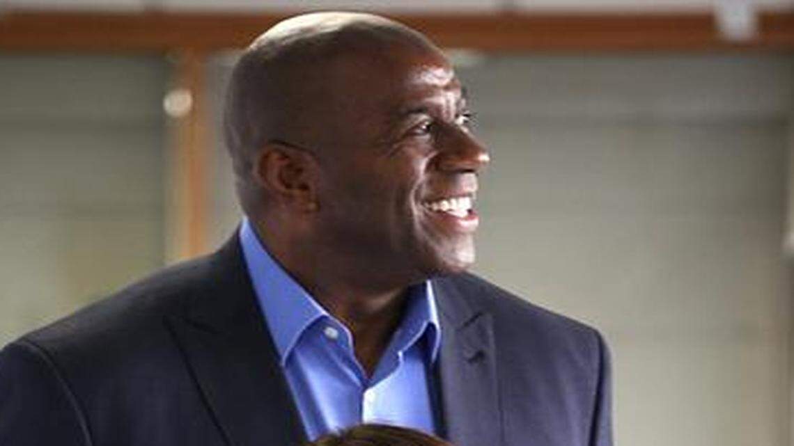 
Team players: CEO Lourdes Rivas, front, poses with Magic Johnson at Simply Healthcare’s headquarters in Coral Gables. Johnson is a shareholder and works to promote the company, especially among underserved, urban communities in Miami-Dade and Broward.
