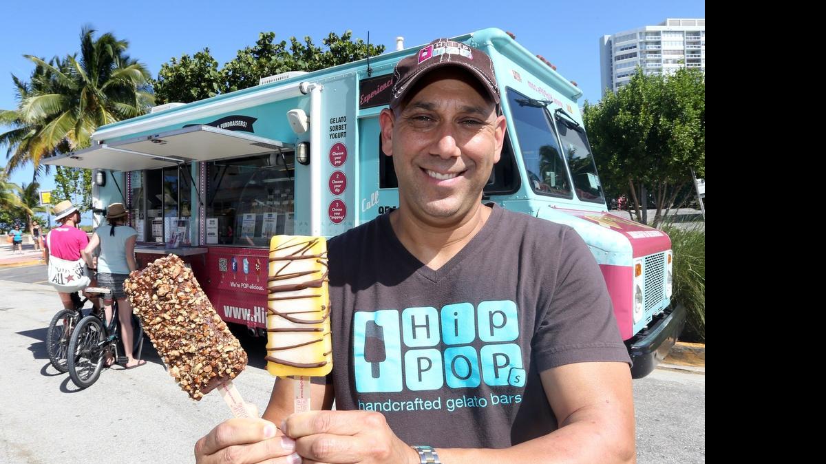 
Anthony Fellows, CEO of HipPOPs, shows his handcrafted gelato sticks near his food truck at the Miami Beach Music Festival. 
