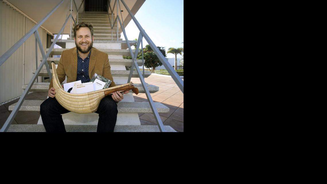 
BETTING ON BOOKS: P. Scott Cunningham, the founder and executive editor of Jai-Alai Books, a literary publishing imprint from Miami, holds a cesta with some Jai-Alai Books publications on Thursday, Nov. 13, 2014 at the National Young Arts Foundation campus, 2100 Biscayne Blvd., Miami. Jai-Alai Books has an office on the campus. 
