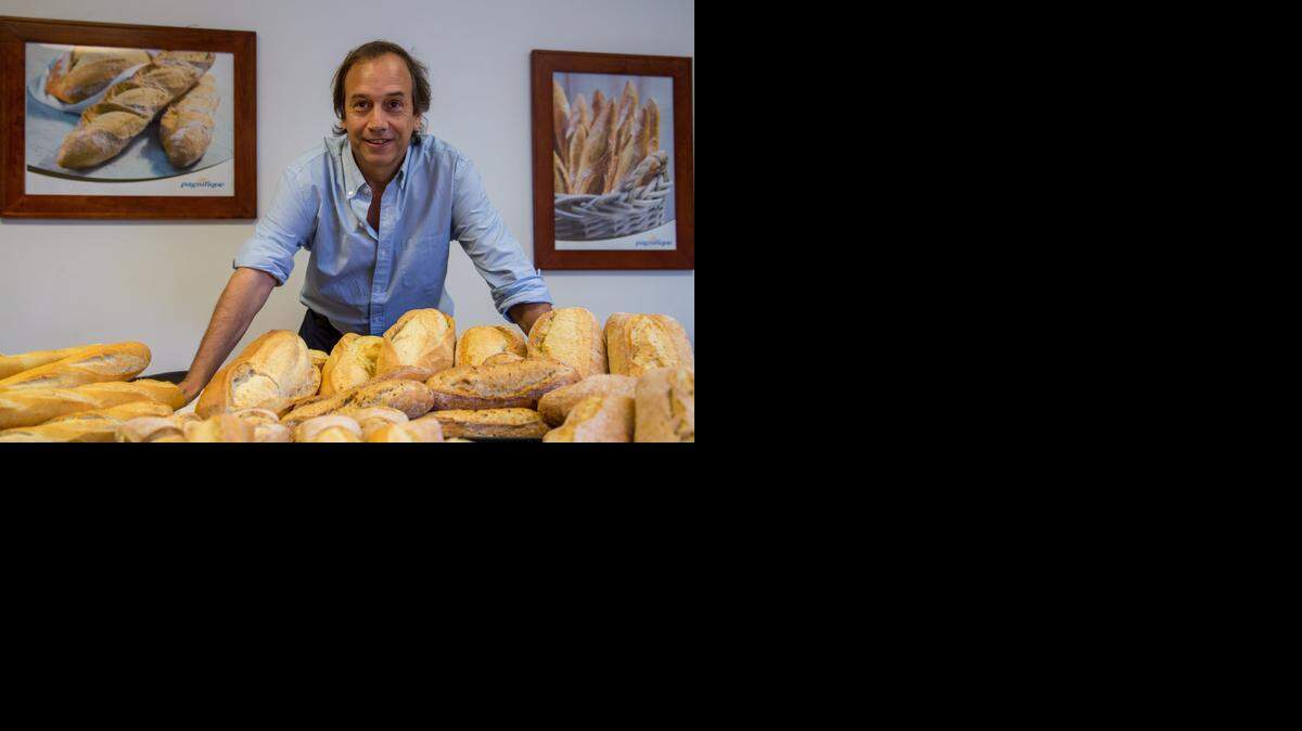 
IN MIAMI-DADE: Fernando Abella, managing director of Pagnifique, poses with some of the company’s various bread products. ‘We are working to be the best bread-maker in Florida,’ he said.



