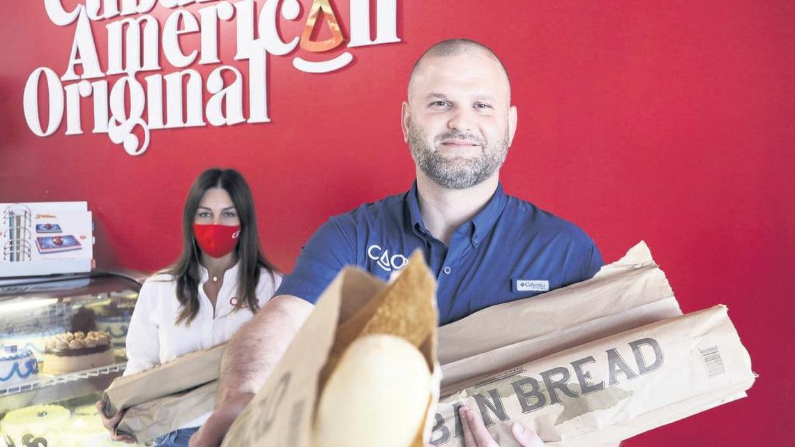 Yvette and Tony Cao inside the Coral Way location of CAO Bakery, which has been providing a free loaf of Cuban bread to anyone who visits the stores —customers and non-customer alike —each Monday since mid-March.