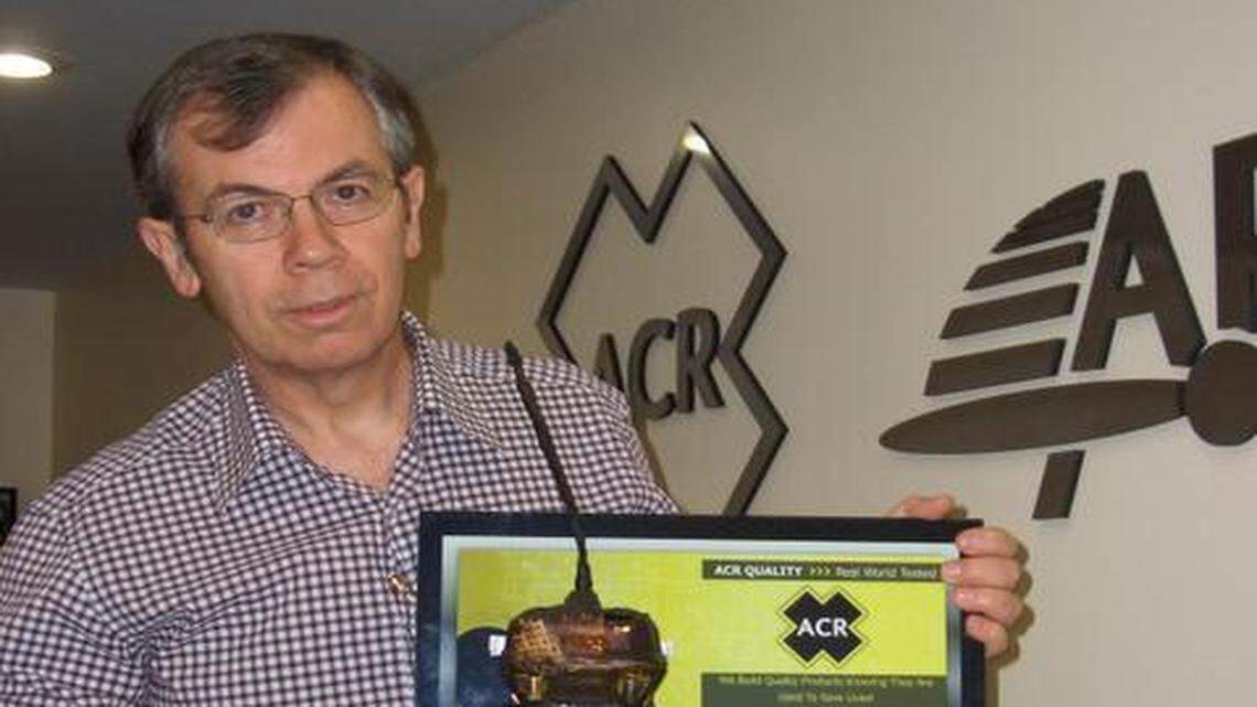 
 Gerry Angeli, head of ACR Electronics, with a marine emergency beacon (EPIRB) that survived a fire but still is working. 
