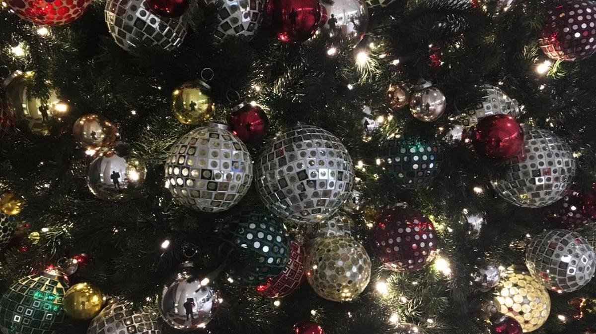 Ornaments hang on a Christmas tree on display in New York.