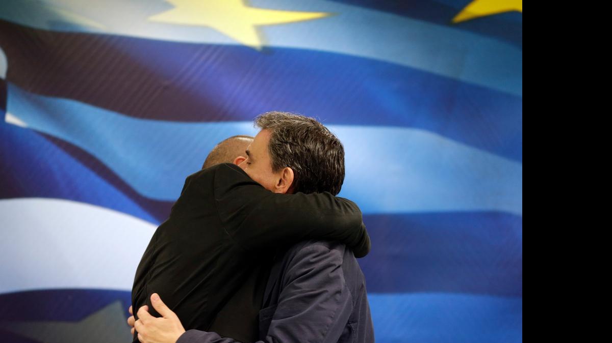 
New Greek Finance Minister Euclid Tsakalotos, right, and outgoing Finance Minister Yanis Varoufakis hug during a hand over ceremony in Athens, Monday, July 6, 2015. Despite triumphing in a popular referendum vote against austerity, Greece on Monday faced the urgent need to heal its ties with European creditors and reach a financial rescue deal that might prevent it from falling out of the euro,
