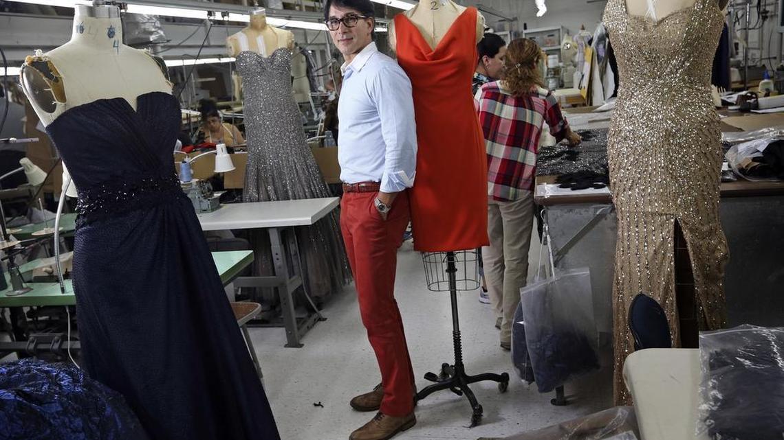 Fashion designer Rene Ruiz, with some gowns made at his Hialeah factory, which now employs 55 craftspeople. He has high hopes for the new MDC program.