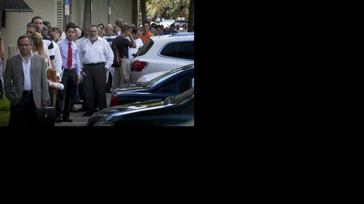 
A line of job seekers wait to enter a job fair at Shula's Hotel in Miami Lakes in 2013.
