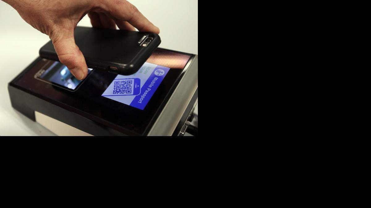 
Faster service: Traveler Louis Nicastro scans the barcode on his Mobile Passport app profile as he clears passport control at MIA.
