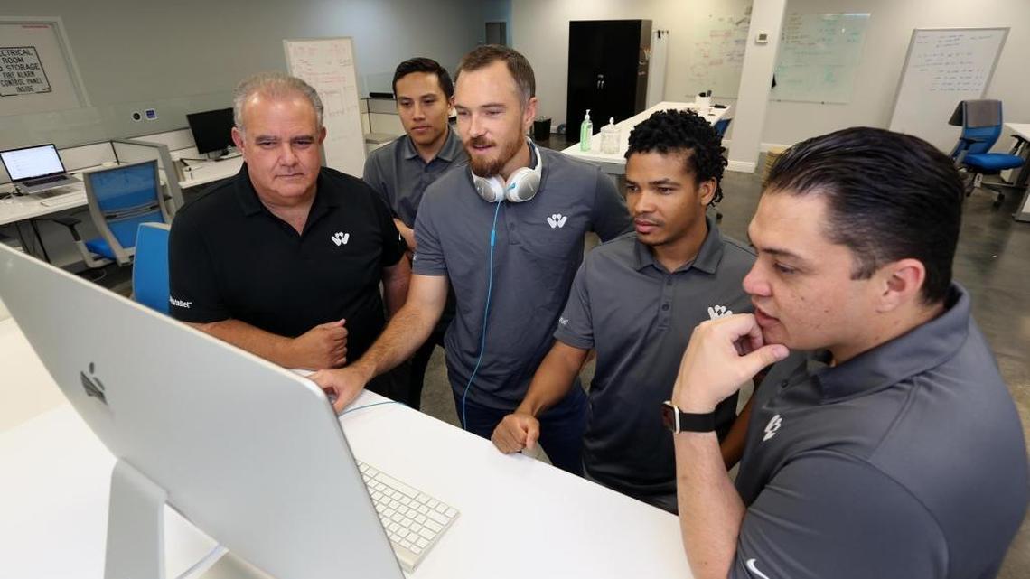 From left: Norberto Menendez, CEO and founder of Life Wallet; Anthony Alviz, software engineer, Scott Johns, design lead, Yaismel Miranda, software engineer; and Kyle Carriedo, engineer manager, at the company offices at 14591 SW 120th St. in Miami-Dade.