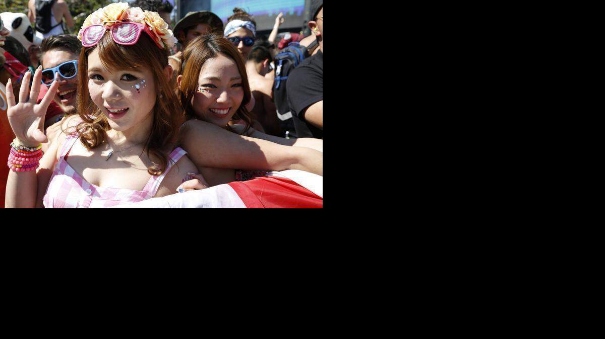 
Yurie Sugimoto, left, and Rie Moritani, right, both from Japan, enjoy Ultra Music Festival on Sunday, March 29, 2015.
