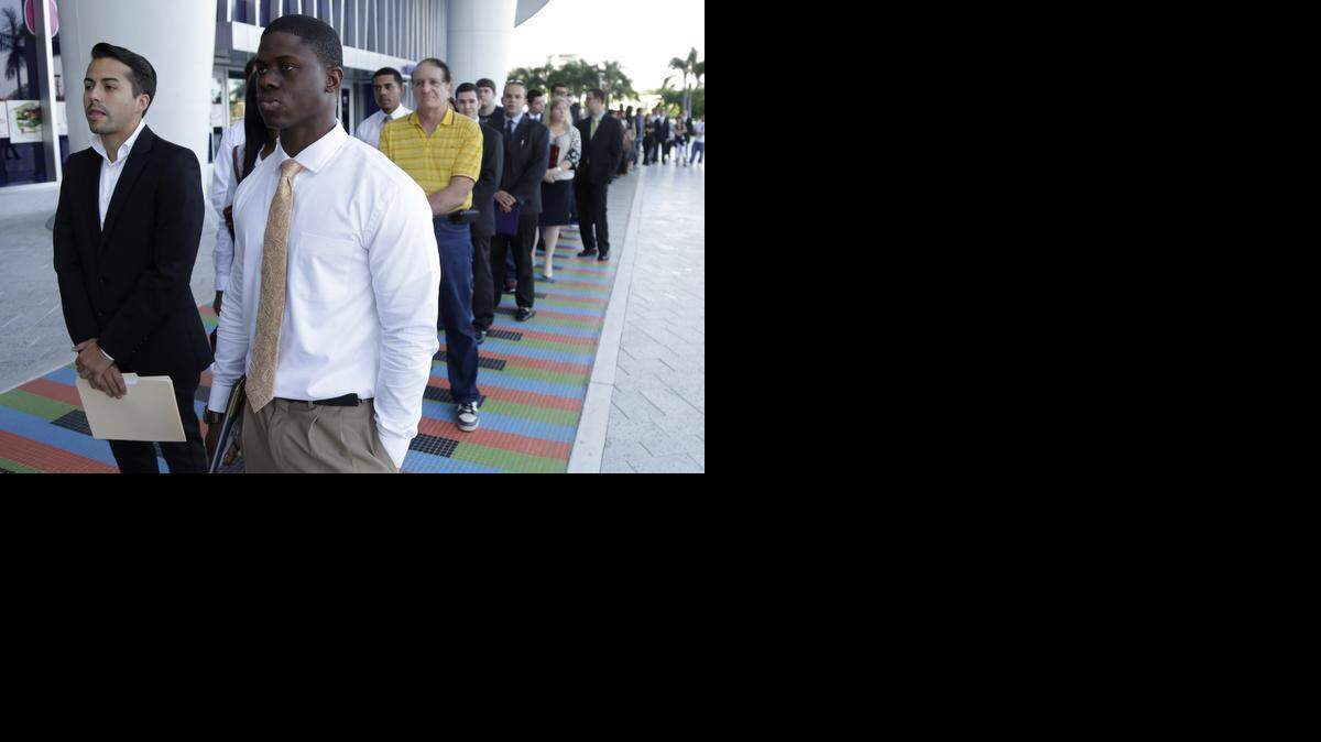 
College students wait in line at a job fair held at Marlins Park in 2013. 

