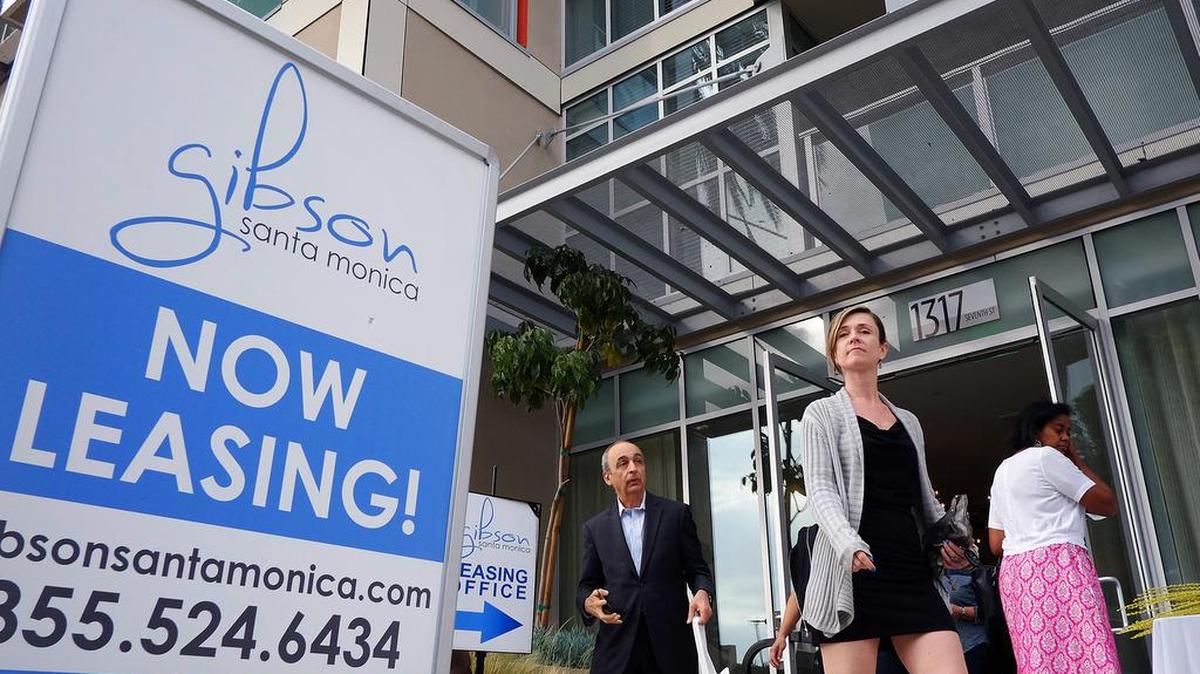 In this Wednesday, March 18, 2015 photo, visitors arrive for the grand opening of Gibson Santa Monica, a new luxury apartment complex in downtown Santa Monica, Calif.