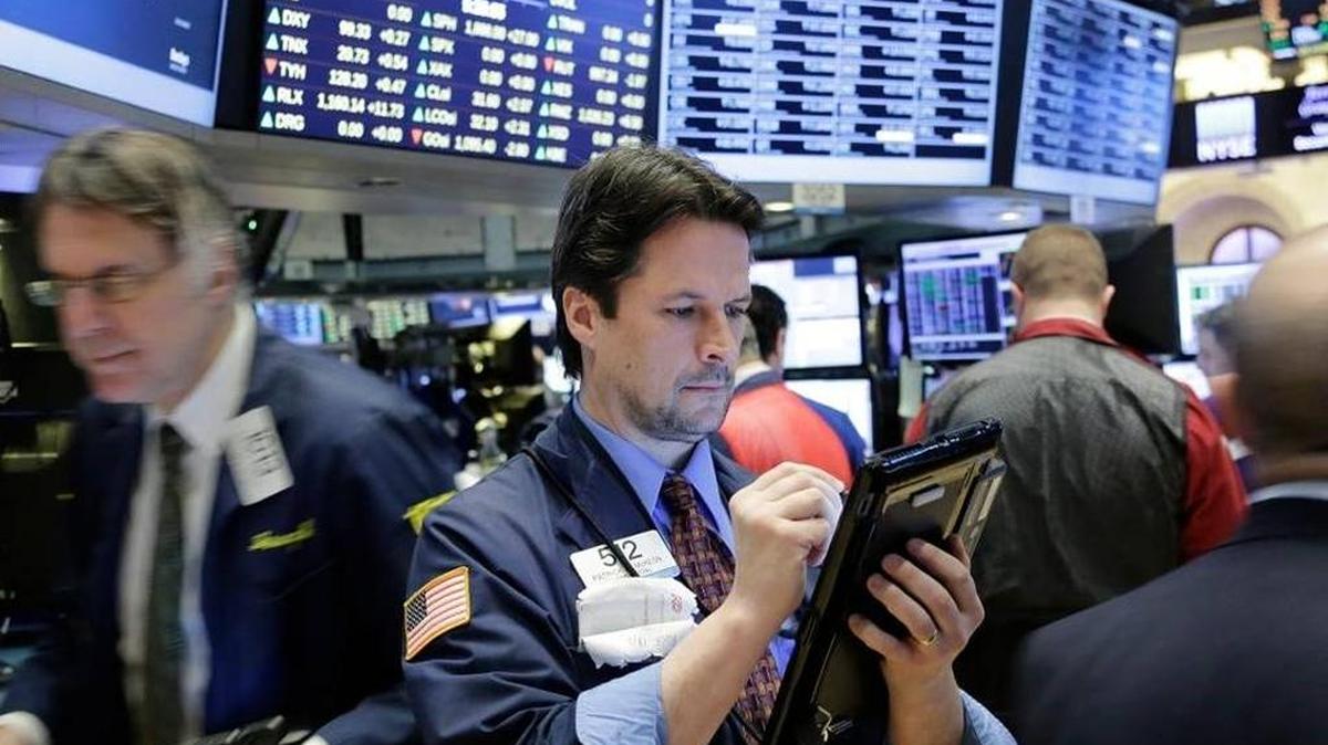 Traders work the floor on Wall Street.