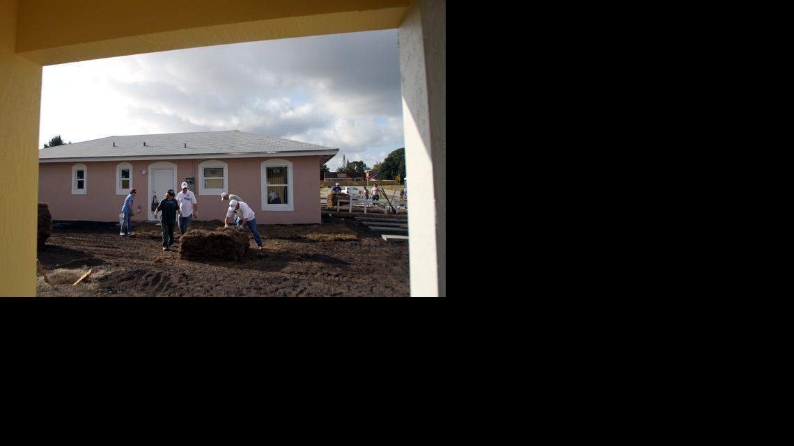 
Members of the Knights of Columbus and the Columbiettes landscape new homes in South Miami Heights during a Habitat for Humanity event to build affordable housing in 2013.
