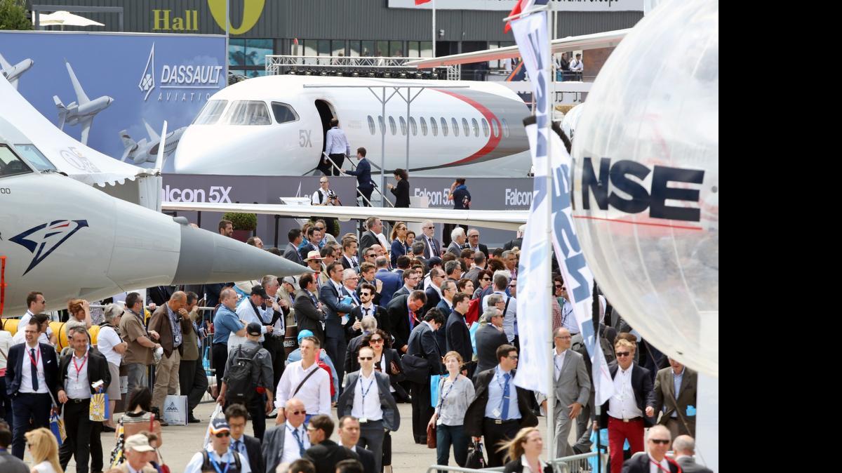 
Visitors crowd the alleys of the Paris Air Show in Le Bourget, north of Paris, Tuesday June 16, 2015. 
