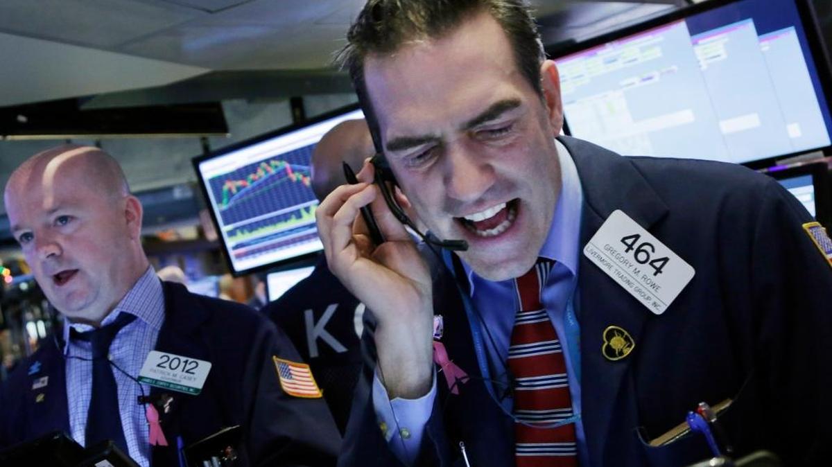 Stock trader Gregory Rowe works at the New York Stock Exchange, Friday, Jan. 15, 2016.