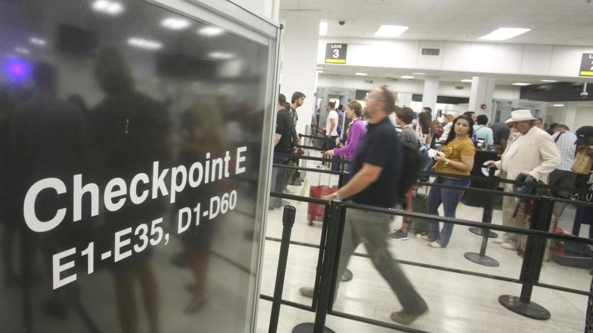 Passengers wait to go through TSA security at Miami International Airport's Checkpoint E on Sept. 10. Finance website NerdWallet, ranked Miami International Airport fifth among the best airports in the country for holiday travel, while an analysis by AirHelp, a start-up legal service for air travelers, ranked MIA No. 7 among the worst airports for Thanksgiving flight delays.