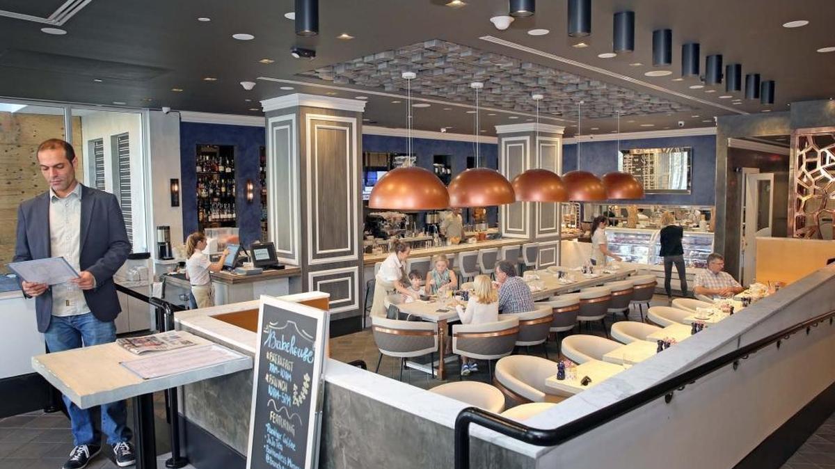 Bakehouse Brasserie in South Beach is suing the city of Miami Beach after city inspectors ruled that its live saxophone played on Sundays from 11 AM through 2PM in the afternoon violates city codes. In this photo, Omar Ahcar, left, general manager for the restaurant, looks over today's menu.