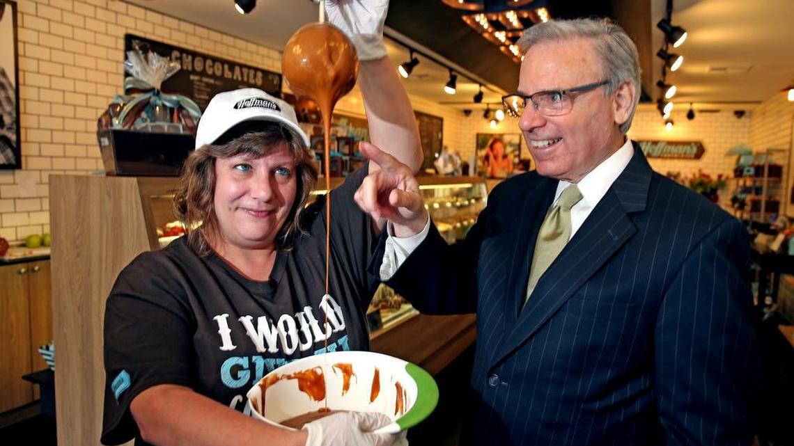 Alan Levan, chairman and CEO of BBX, watches as Rosemary Ullrich dips apples in carmel at Hoffman's Chocolates on East Las Olas Blvd, June 21, 2017. Hoffman’s is one of the companies in BBX’s portfolio.
