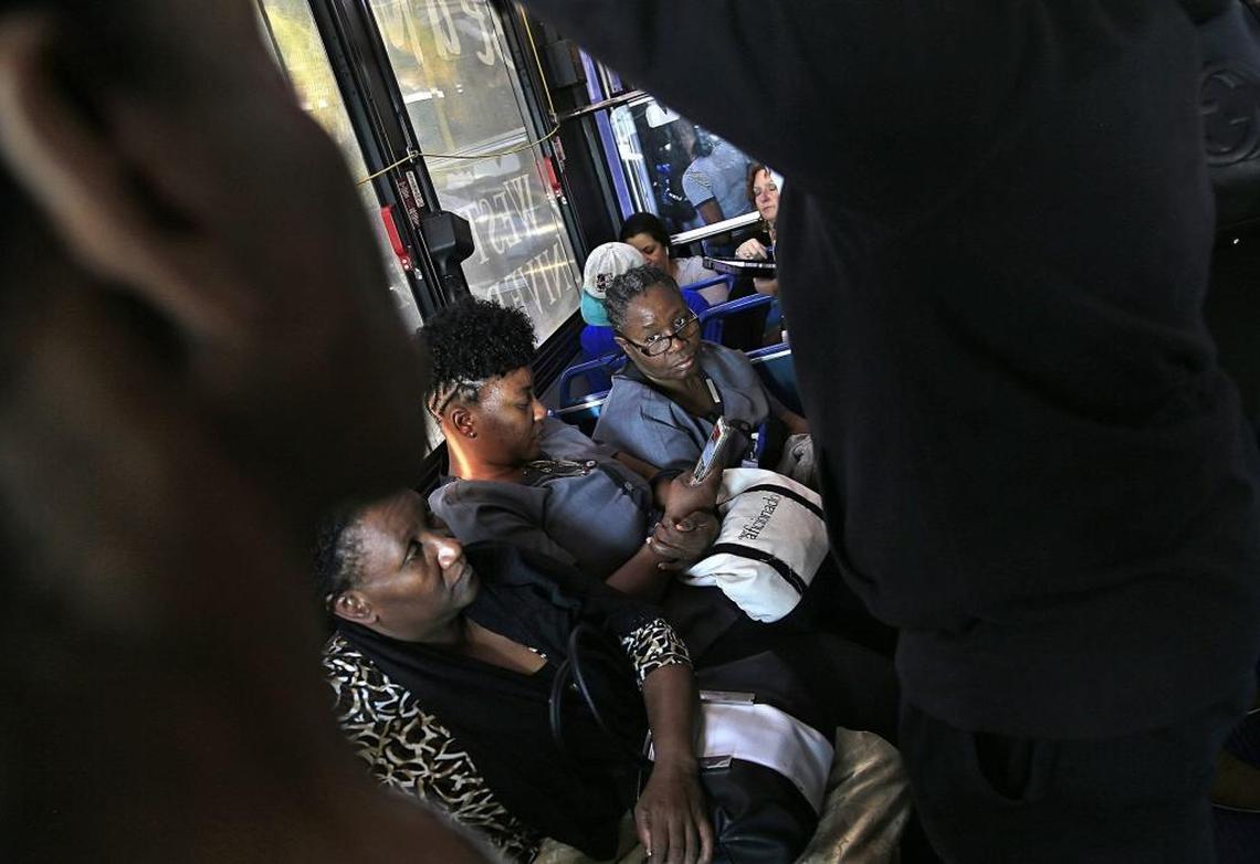 Fontainebleau housekeeper Odelie Paret, right, heads home on a packed bus from her job on Miami Beach. This commute sometimes takes up to three hours, a side effect of Paret’s move to Opa-locka from the Upper East Side because of rising rents. Before, her commute home could take as little as 30 minutes.