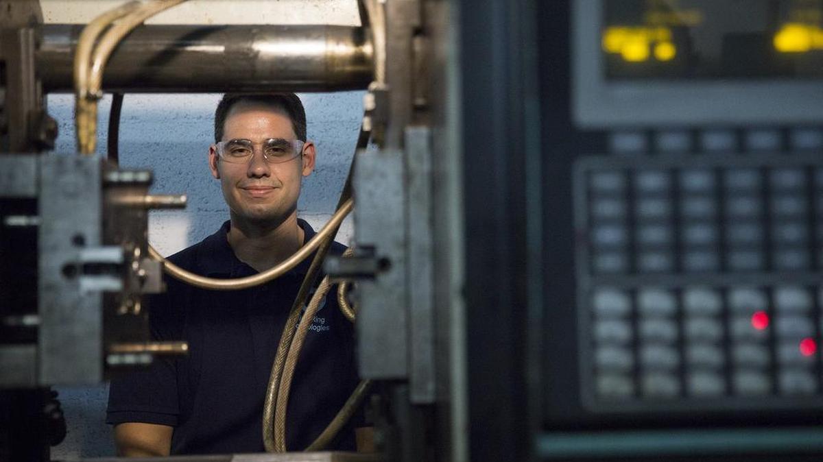 
Jay Prendes, 33, president of Blue Ring Technologies, poses behind an injection molding machine at the Blue Ring manufacturing faciilty in Davie. Blue Ring acts as a one-stop shop for inventors, from product design to prototypes to manufacturing.
