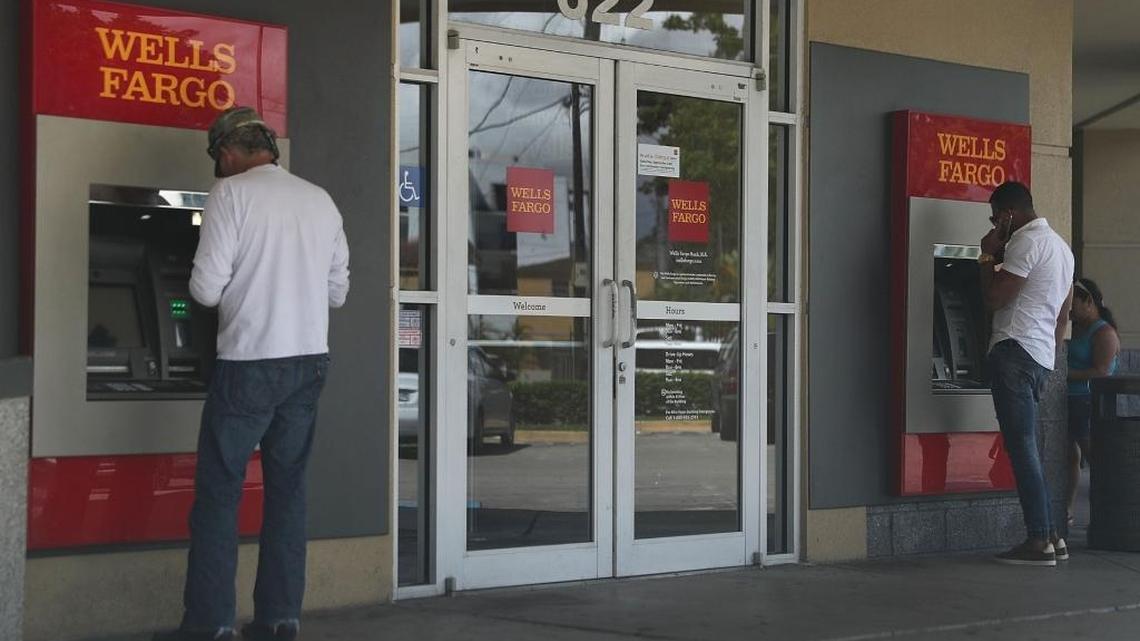 Customers use a Wells Fargo ATM at one of their bank branches in Miami, Florida. A class-action case in Miami federal court against Wells Fargo asserts the bank violated consumer protection laws in how it handled debit fees.