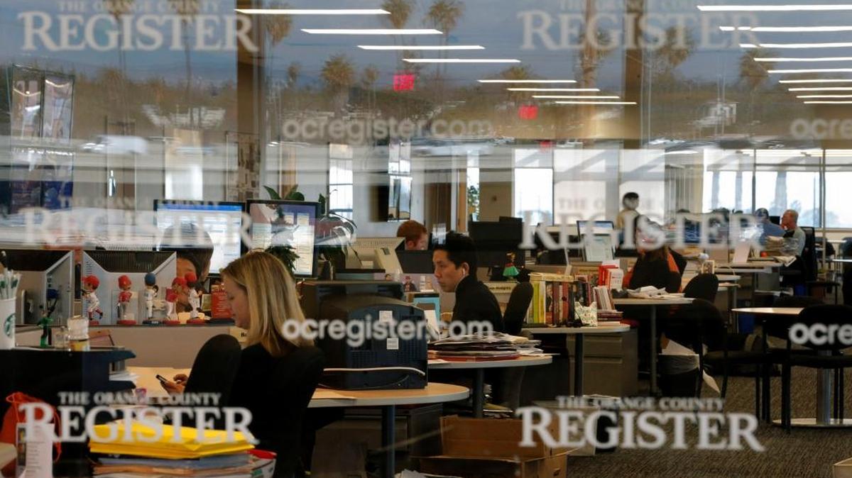 This Dec. 27, 2012 file photo shows the newsroom of the Orange County Register in Santa Ana, Calif. Tribune Publishing said Thursday, March 17, it placed the winning bid at an auction of the Southern California suburban newspapers owned by bankrupt Freedom Communications.